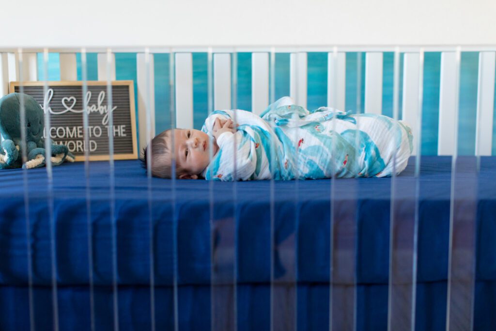 baby boy in crib ocean themed