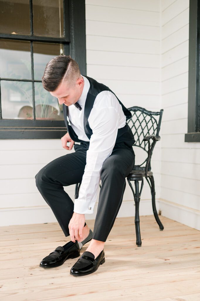 Groom putting on shoes