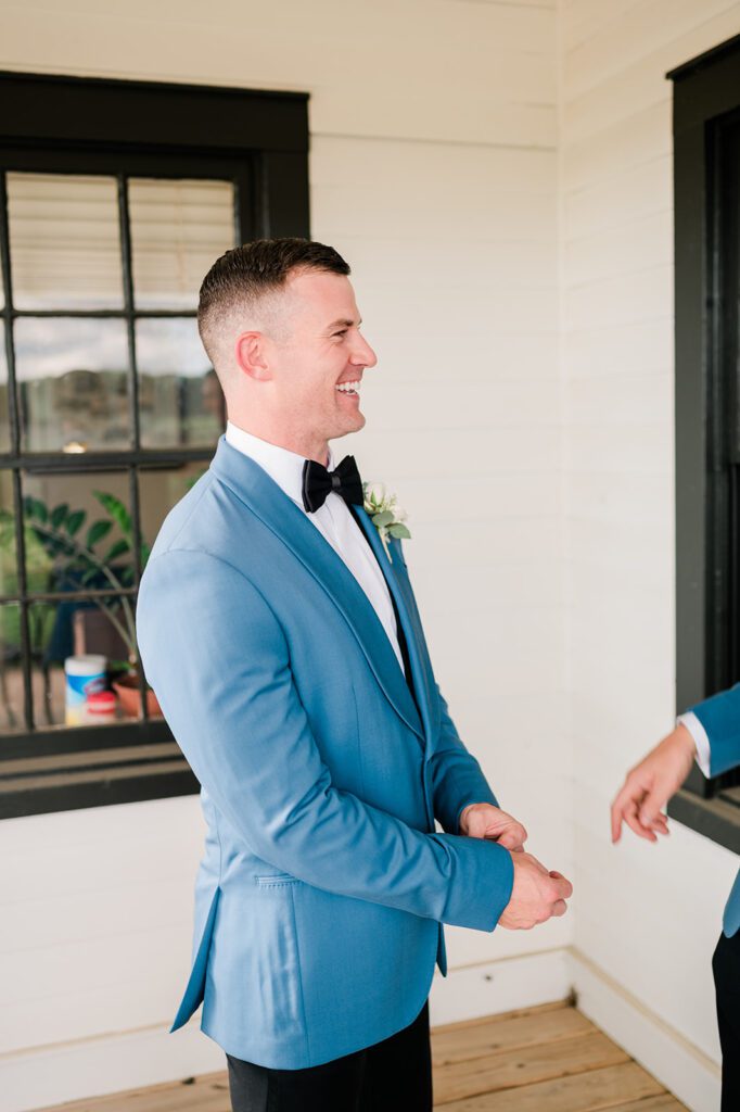 Groom Laughing in blue tuxedo