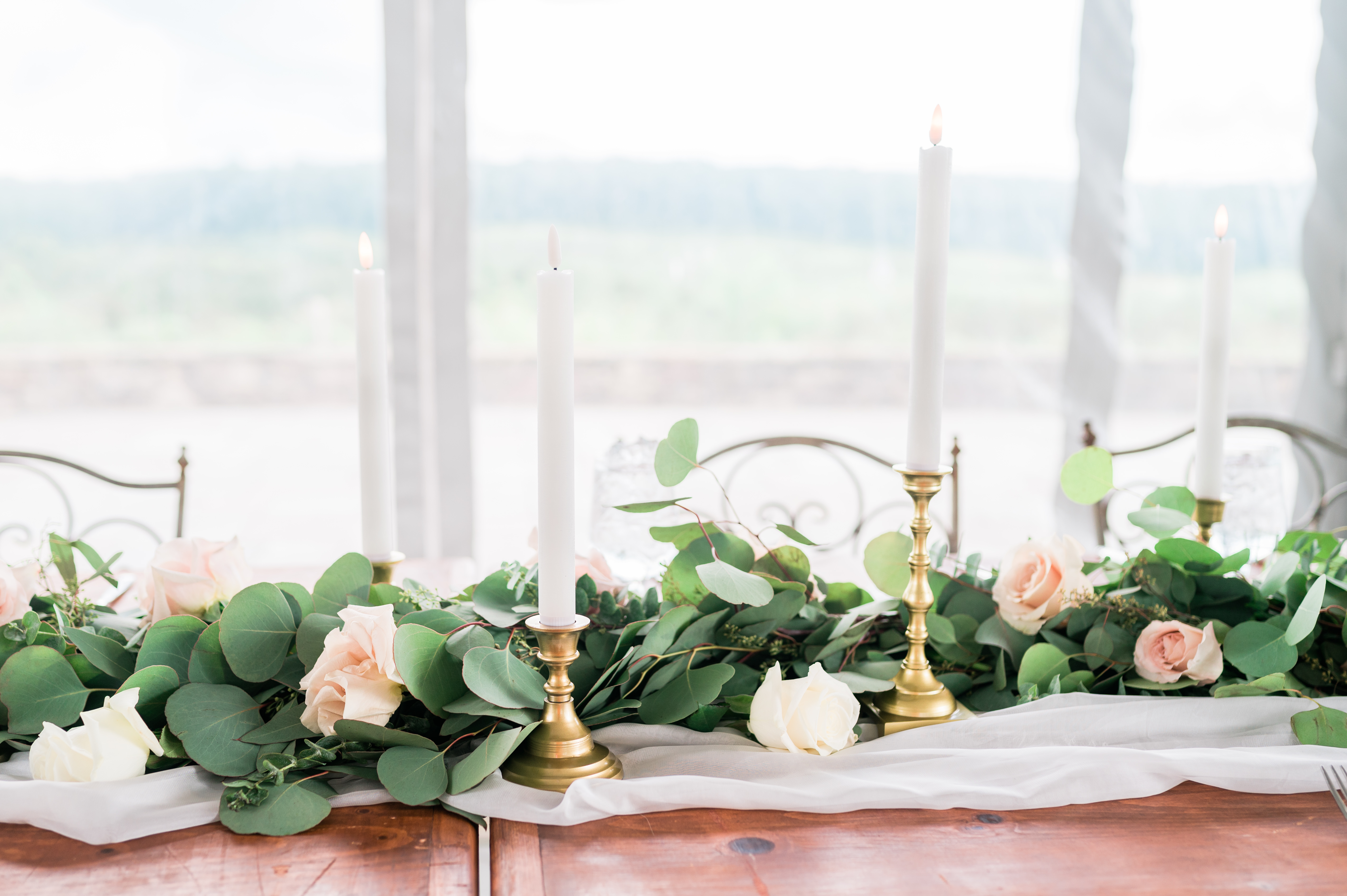 Wedding table decor - eucalyptus, vintage candles, and roses