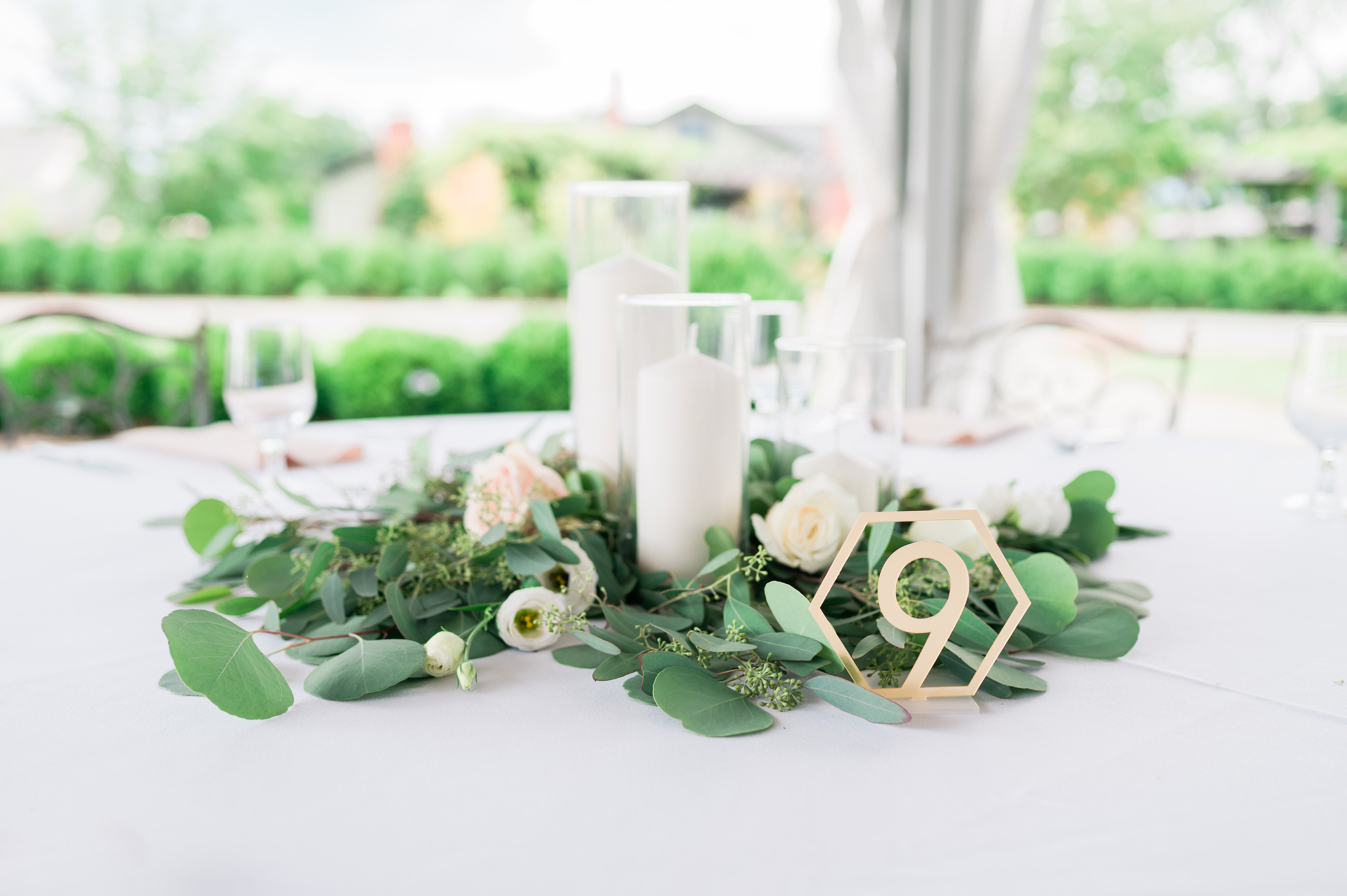 Wedding reception centerpiece- eucalyptus, roses, and candles