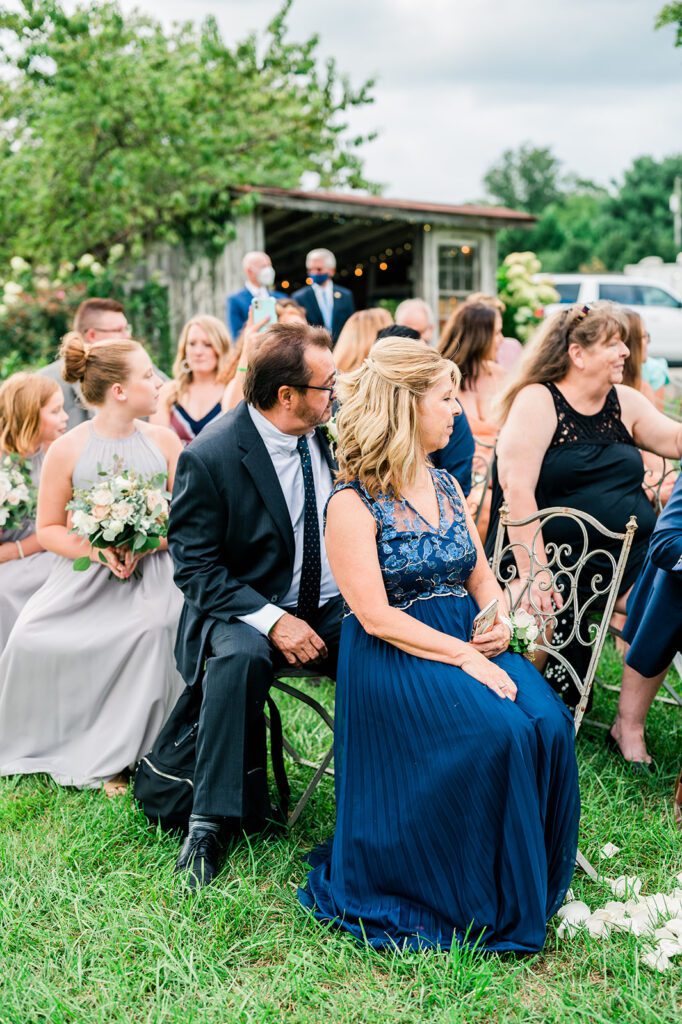 Wedding guests looking at bride