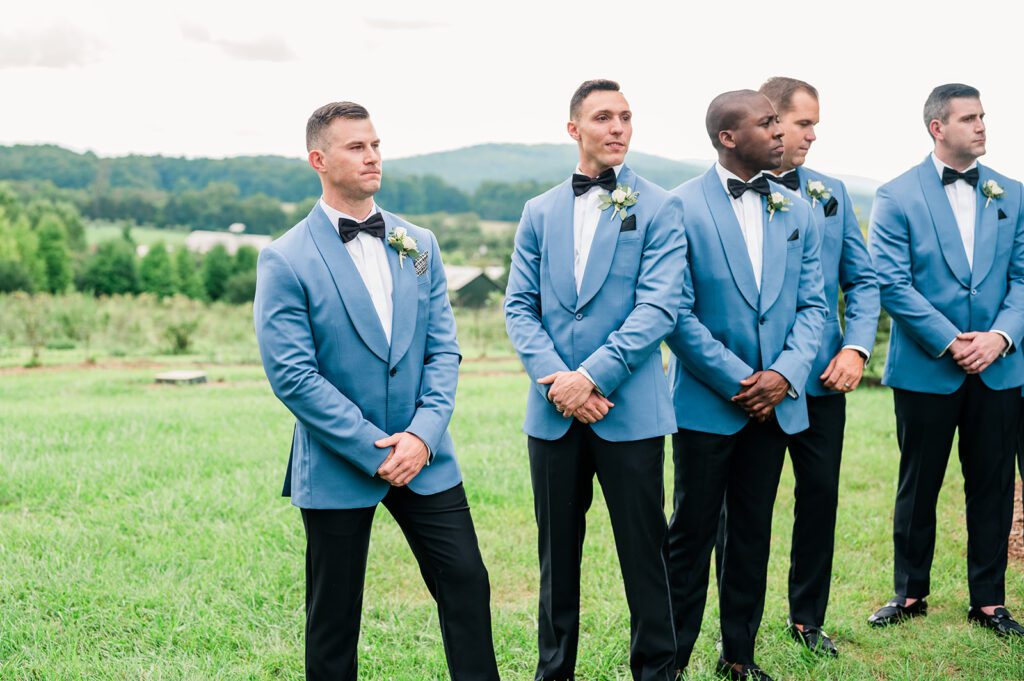 Groom crying looking at bride coming down the aisle