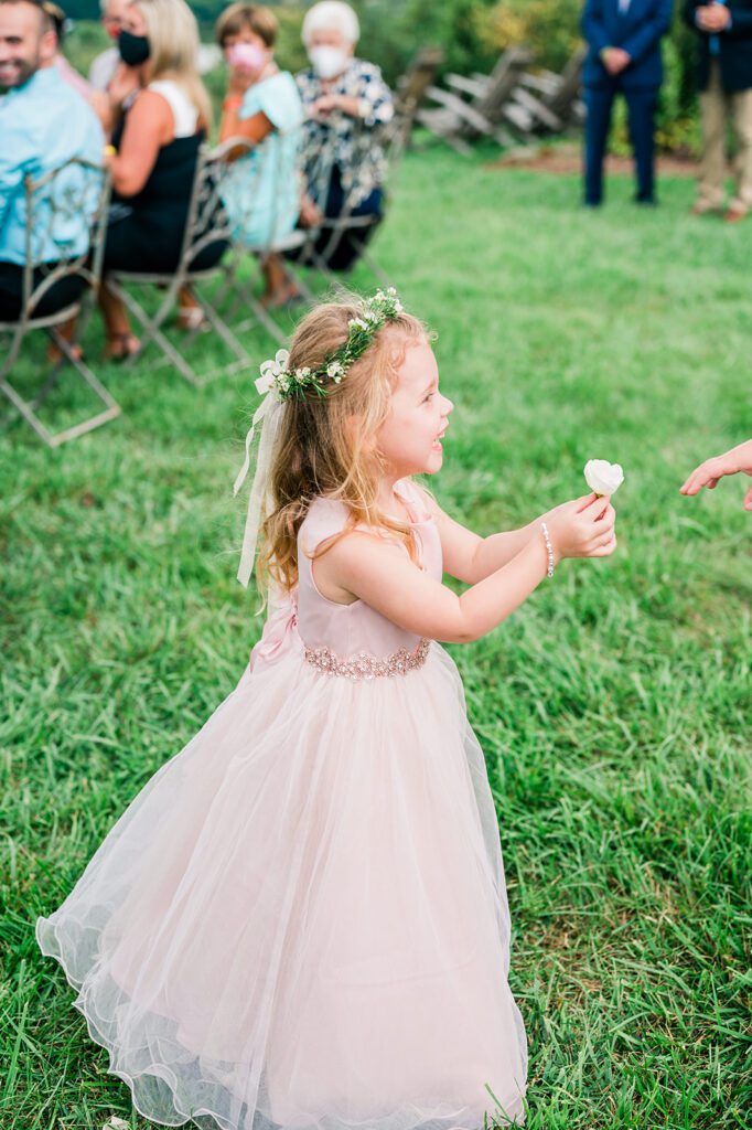 Flower girl in pink dress outside