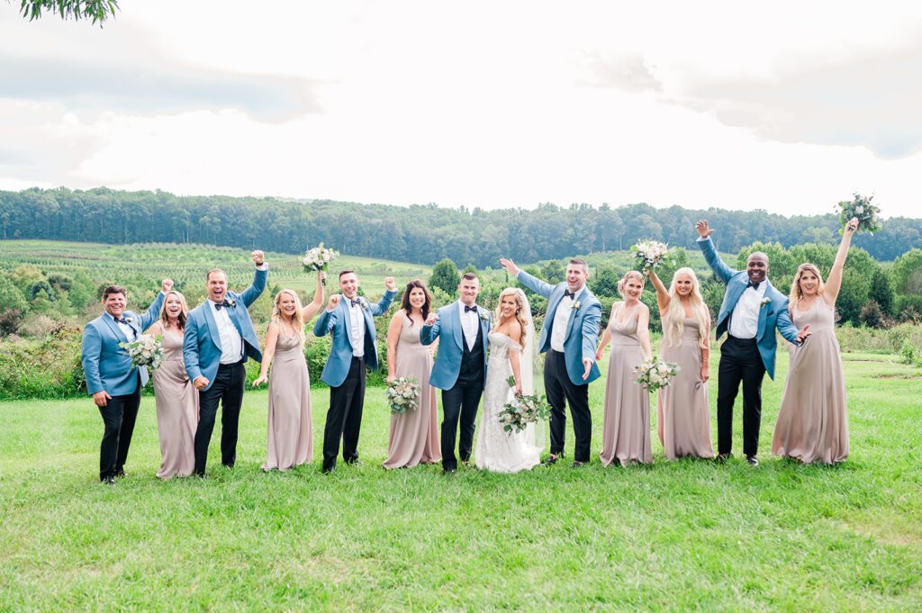 Wedding party at vineyard in champagne dresses and blue tuxedos