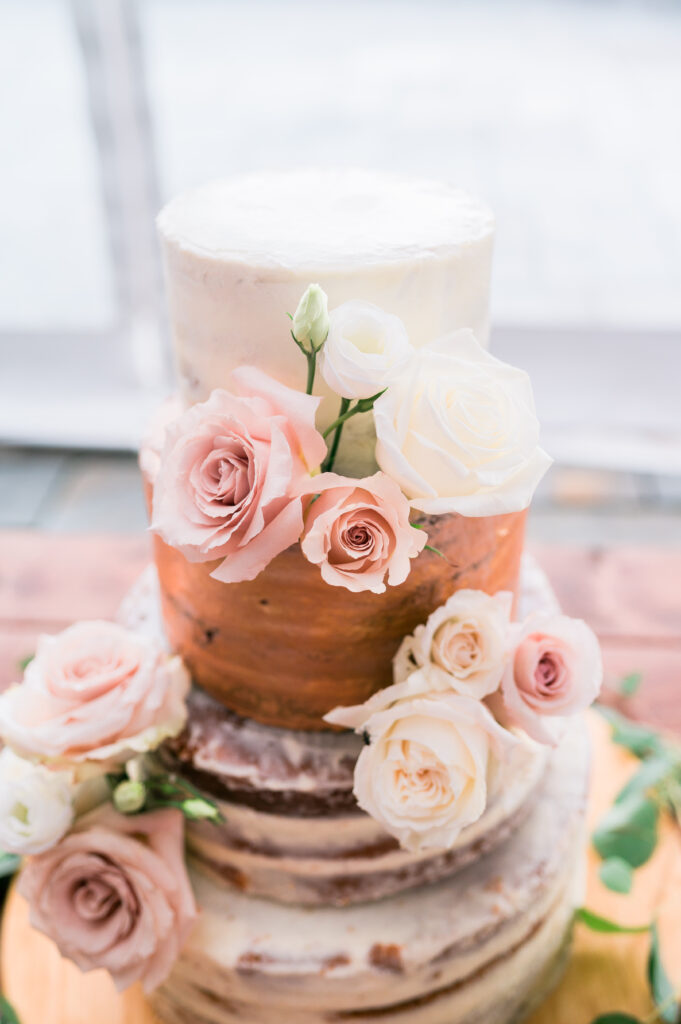 Rustic naked wedding cake with flowers