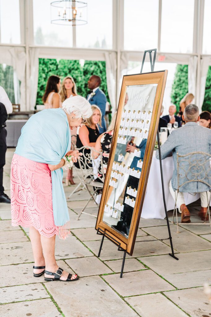 Wedding guest looking at seating chart