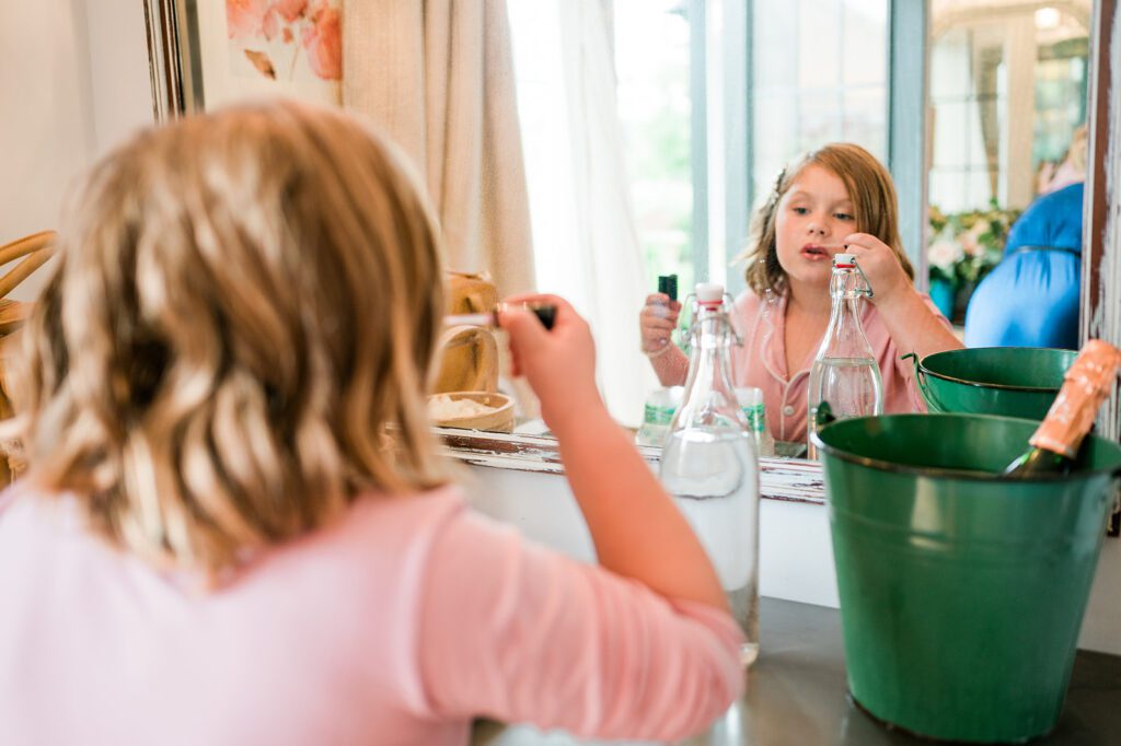 Junior Bridesmaid putting on lip gloss