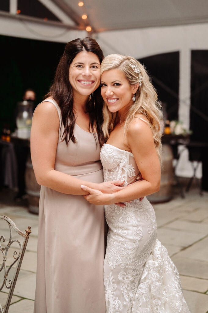 Sisters hugging at wedding reception