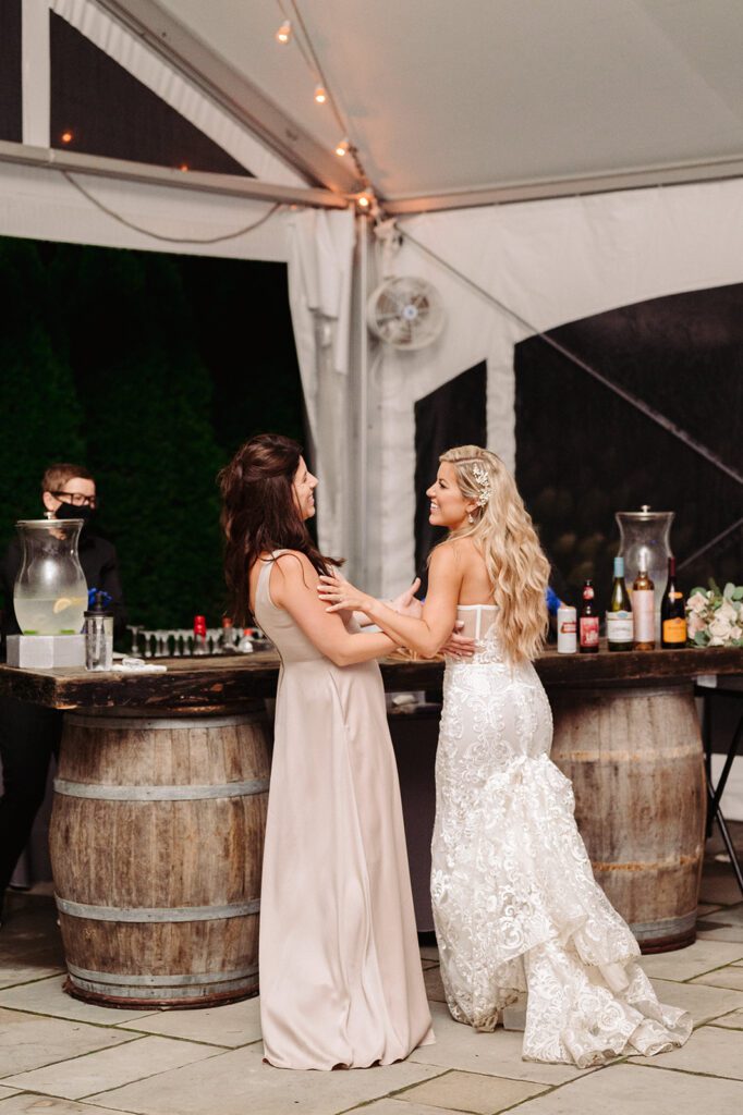 Sisters laughing at wedding reception