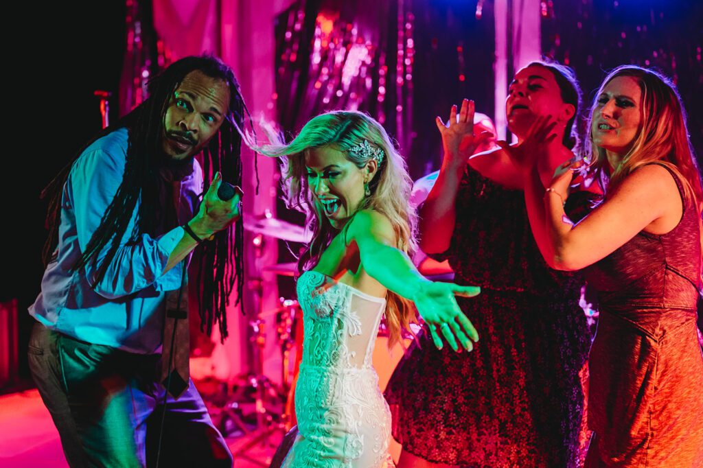 Bride and friends dancing with live band at reception