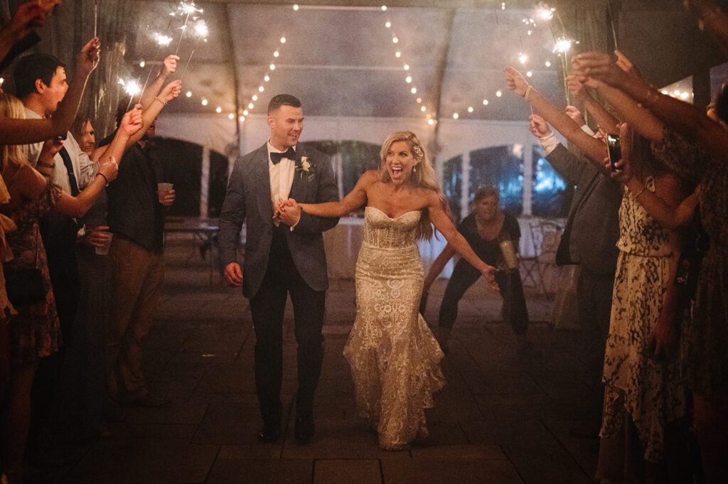 Bride and groom walking in sparkler send off