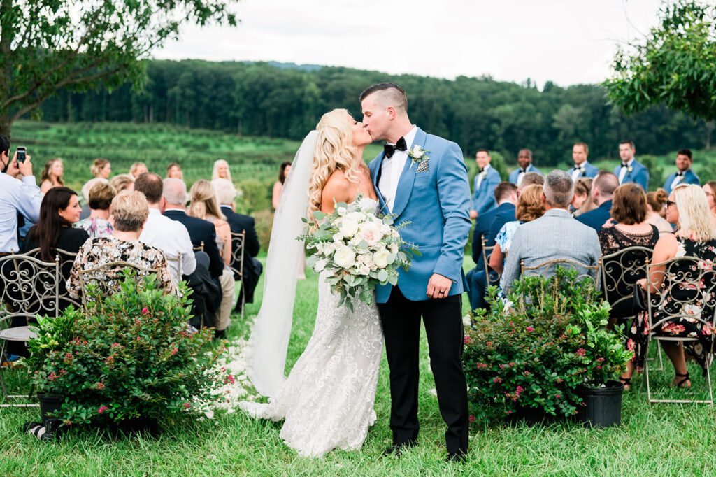 Bride and Groom kissing in vineyard wedding