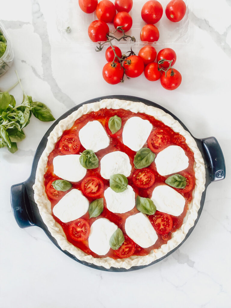 Fresh Mozzarella, tomato and basil toppings on precooked pizza