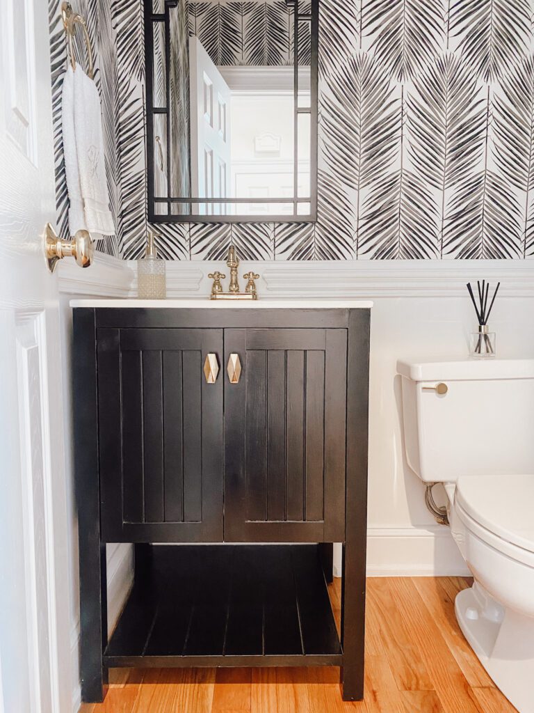 Black bathroom cabinets with brass hardware