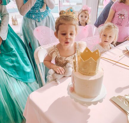 Princess Birthday Party - girl blowing out candles