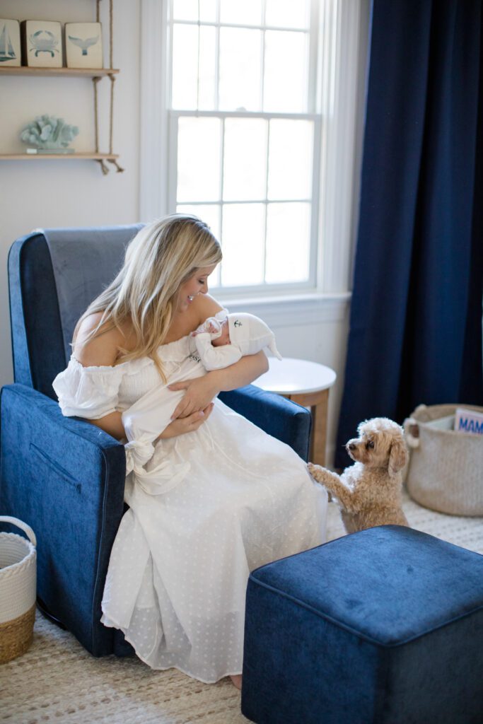 Mother with newborn and dog in rocking chair