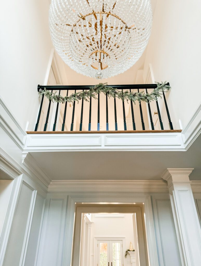 Modern garland on staircase railing with Chandelier