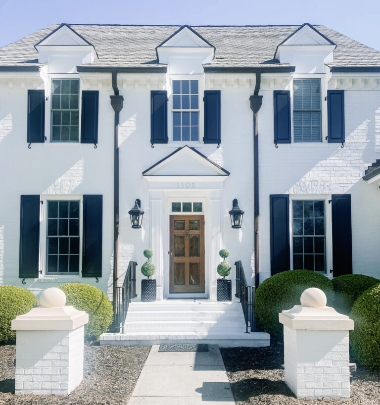 Bright White Brick House with Black Shutters